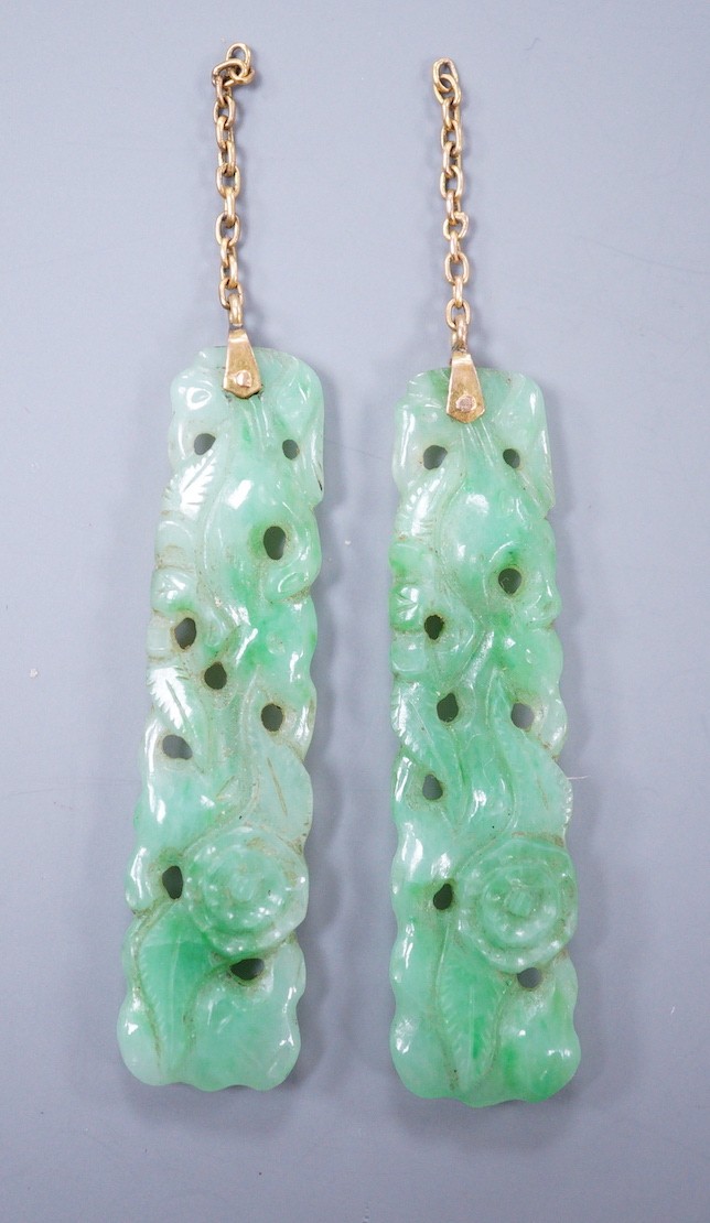 A pair of carved jade earrings, lacking mounts, 37mm.